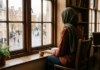 How to Deal With False Accusations: What to Do When You’re Falsely Accused Muslim woman in hijab sitting alone by a window, reflecting on how to deal with false accusations